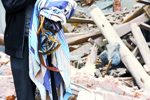 老人手中拿著曾控制住他的電線、床單