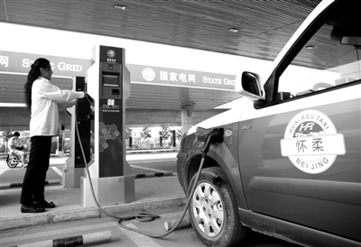 9月11日，懷柔區(qū)，電動(dòng)出租車司機(jī)正在為車輛充電。