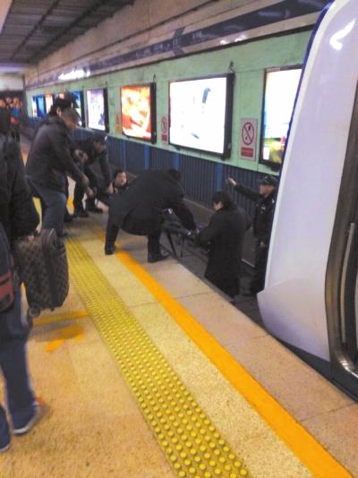 地鐵工作人員將林某從站臺(tái)下救起。網(wǎng)友供圖