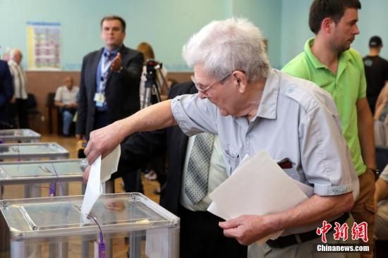 　5月25日，一名烏克蘭選民把填好的選票投入選票箱。