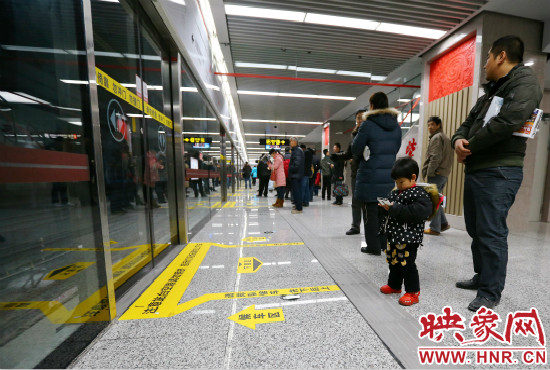 小朋友在等候區(qū)內(nèi)等待地鐵。