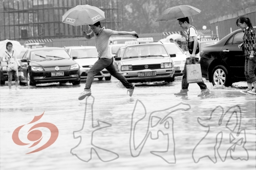 鄭州經(jīng)三路與北環(huán)交叉口處，積水較深，行人們不得不“練輕功”。 記者 白周峰 攝影