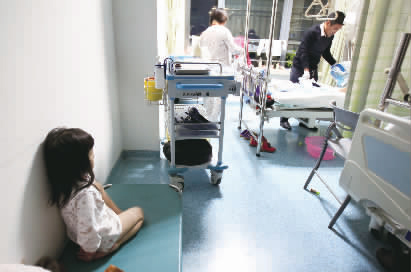 嘟嘟一早就醒了，小小的身體靠在墻邊看著爸爸進(jìn)行手術(shù)前準(zhǔn)備