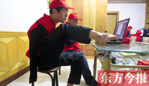 12月2日，一名“豫殘聯(lián)盟”志愿者正通過網(wǎng)絡(luò)、微博等聯(lián)絡(luò)著各地殘疾人朋友 東方今報首席記者 張曉冬
