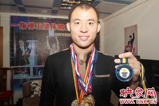樊偉鵬向大家展示自己剛獲得的吉尼斯獎牌。