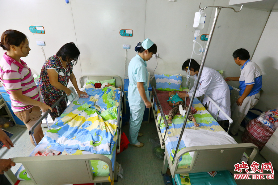 手術(shù)前，畫面右側(cè)的大龍正在接受醫(yī)生的檢查，左側(cè)的小龍還在熟睡。