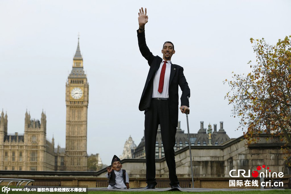 當地時間2014年11月13日，英國倫敦，世界上最矮的男子錢德拉·巴哈杜爾·唐吉與世界上最高的男子蘇