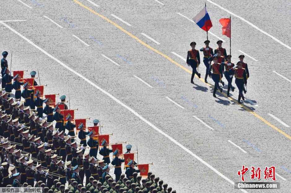 圖為俄羅斯國(guó)旗從受閱部隊(duì)前經(jīng)過(guò)。